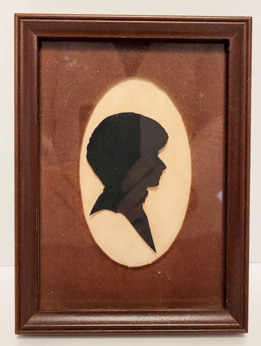 antique paper cut-out silhouette: small paper cut silhouette of a person looking to their right, in wooden frame and with velvet matte