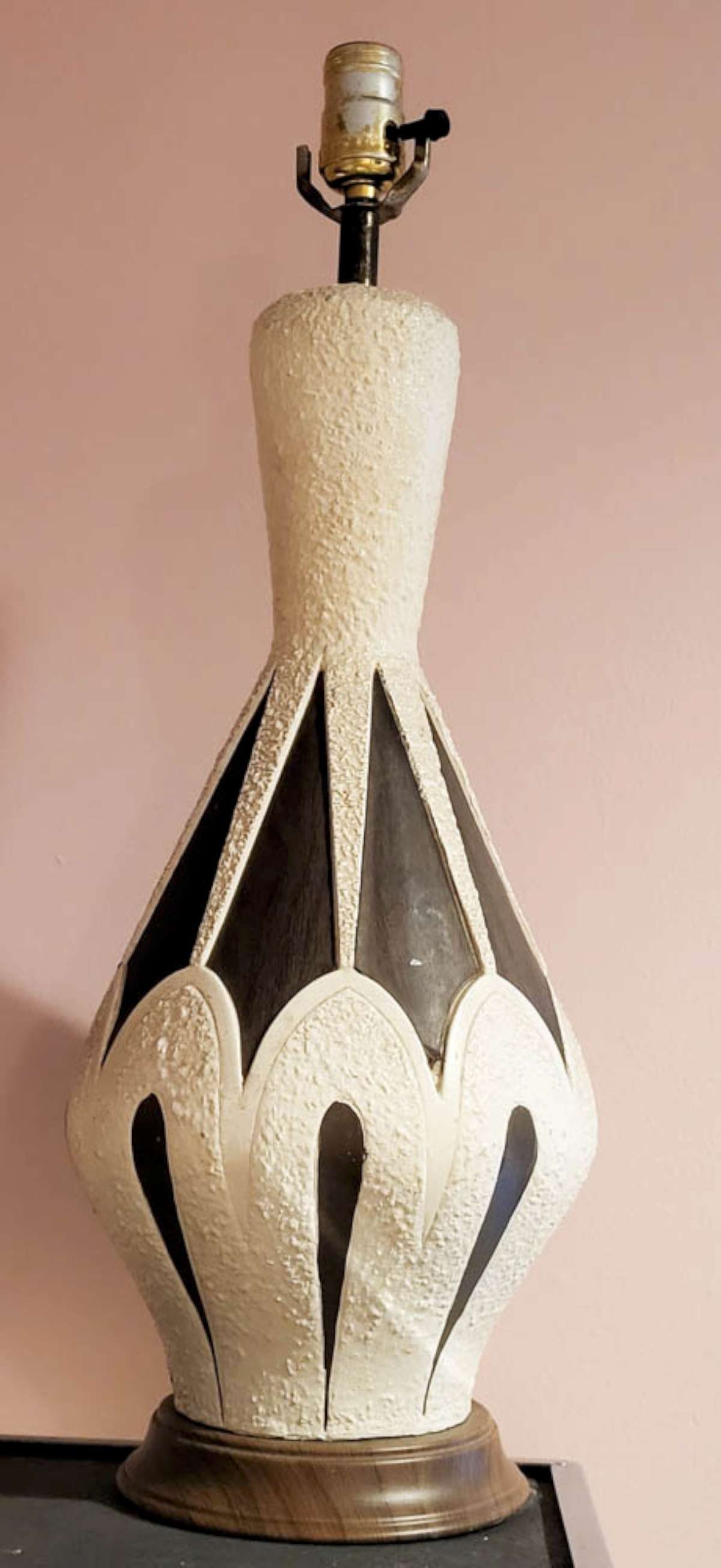 Mid Century Modern ceramic and wood table lamp: vintage late MCM pottery or ceramic tall table lamp by Quartite Creative Corp from 1961 with textured cream colored and wood laminate finish, set on a faux wooden metal base