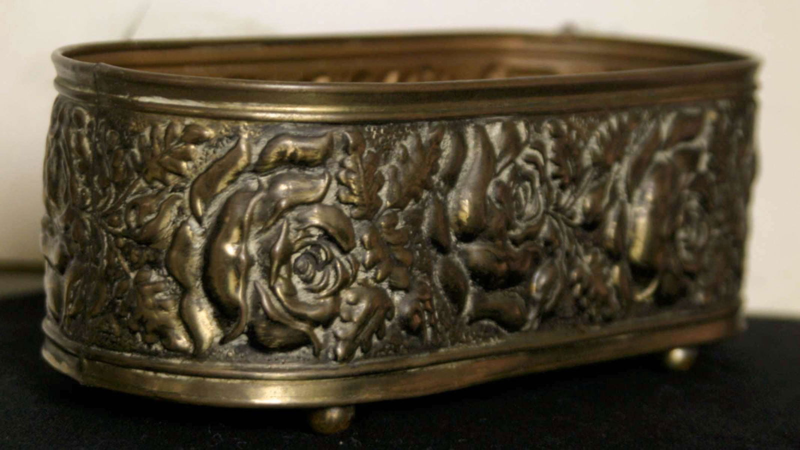 antique brass Art Nouveau planter: repousse floral design with flowers (Roses) jardiniere or plant pot on ball feet, consignor is originally from The Netherlands or Holland, so this is most likely a European piece9" lo