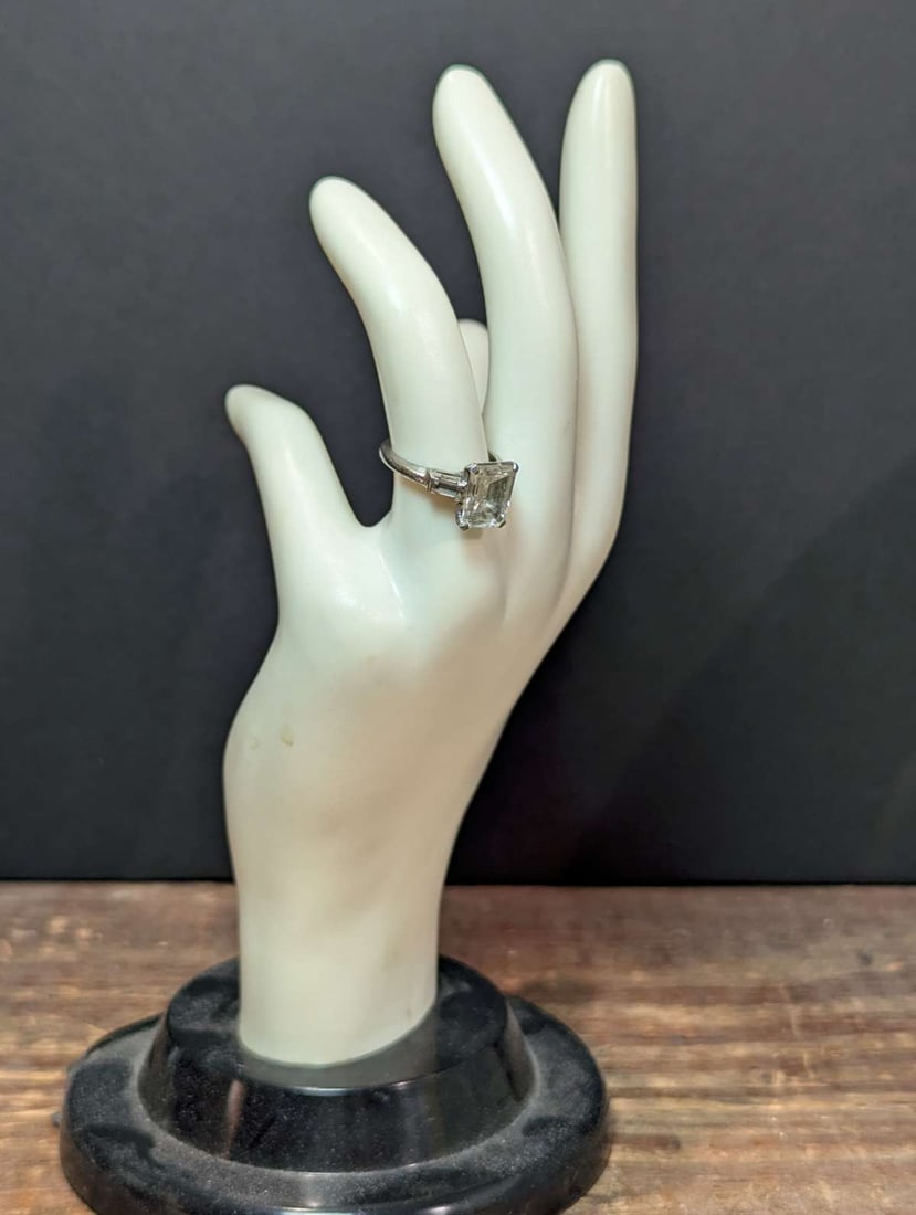 vintage estate jewelry: silver engagement ring: marked Sterling silver ring with 2 baguette clear cut stones flanking a large cut possibly Moissanite stoneabout a ring size 5 3/4