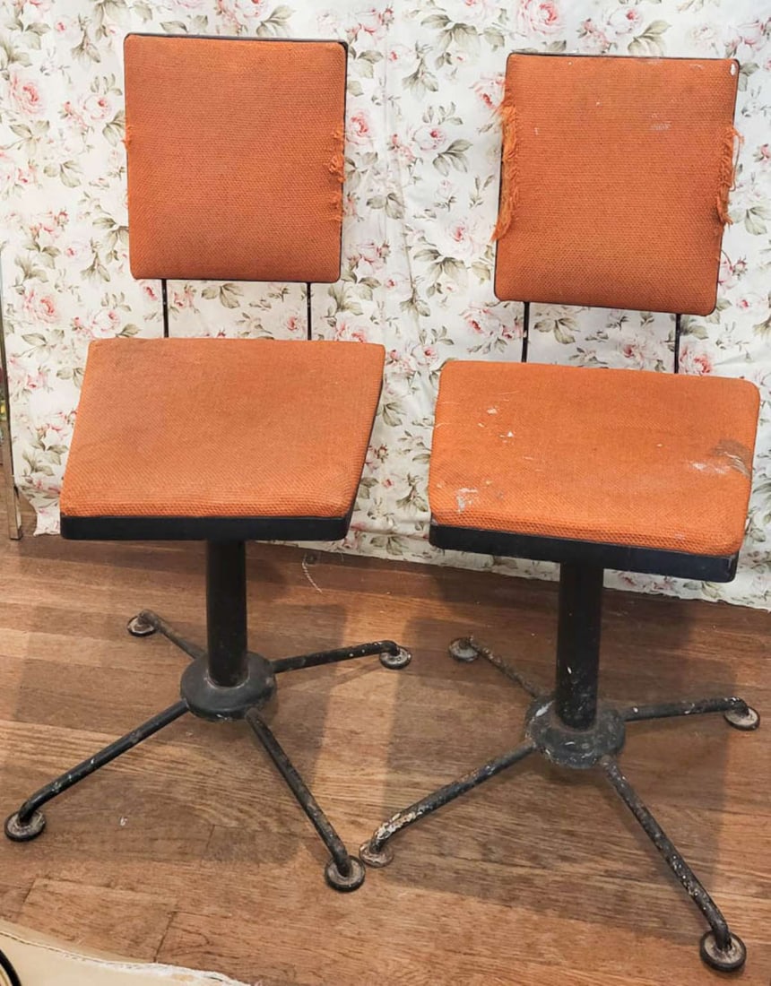 PAIR MCM swiveling Atomic Space Age chairs: ca. 1950's Mid Century Modern Industrial style pair of black steel chairs with original paper label for Syd Leach Inc from Wadley Alabama, with the original orange fabric