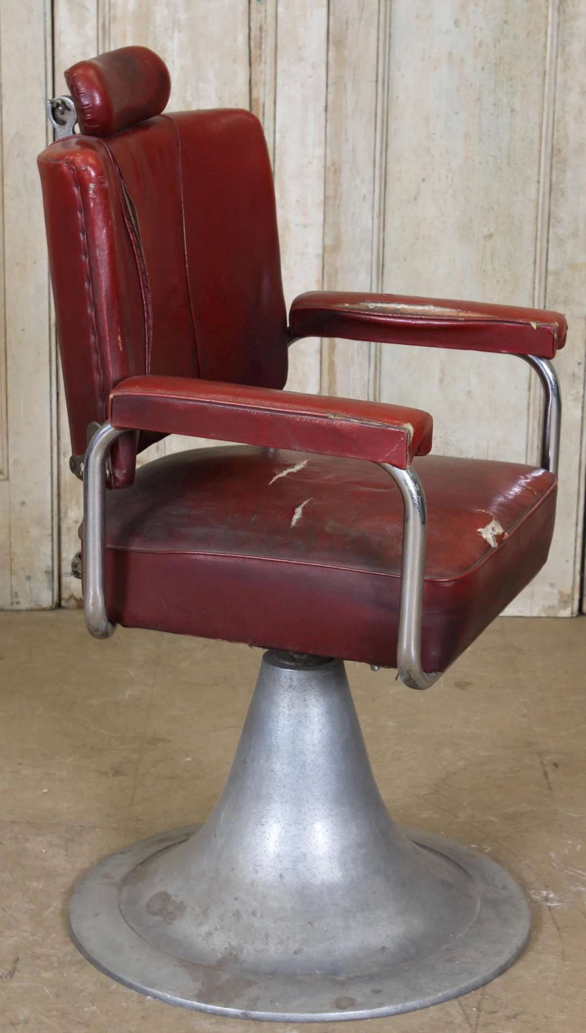 antique MCM barber chair height adjustable: incredibly cool, retro, Mid Century Modern swiveling barber chair with a chromed round tulip shape foot with red leather upholstery and height adjustable parts (need some oil to work