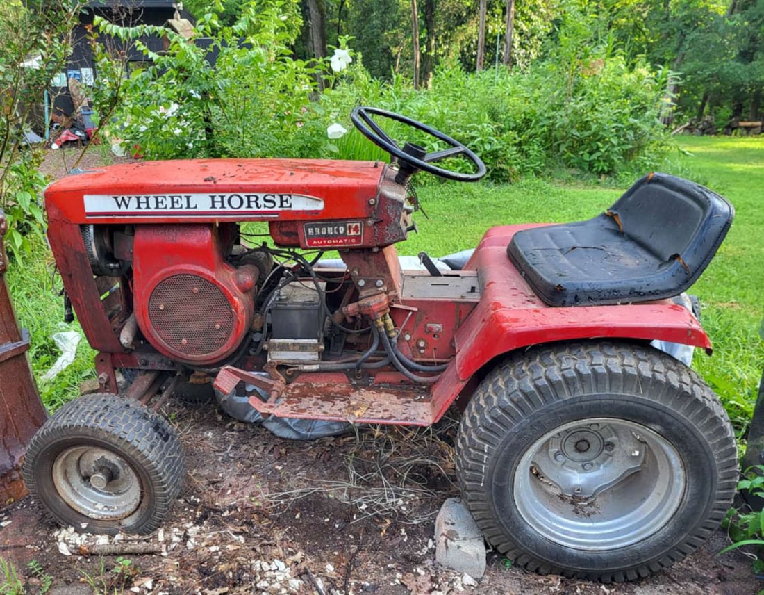 vintage Wheelhorse tractor, cutting deck and cart: vintage 1980's red Wheelhorse steel tractor Bronco 14 automatic with matching cutting deck for grass and a red pull cartNOTE: this piece is not at the store, but still located at the