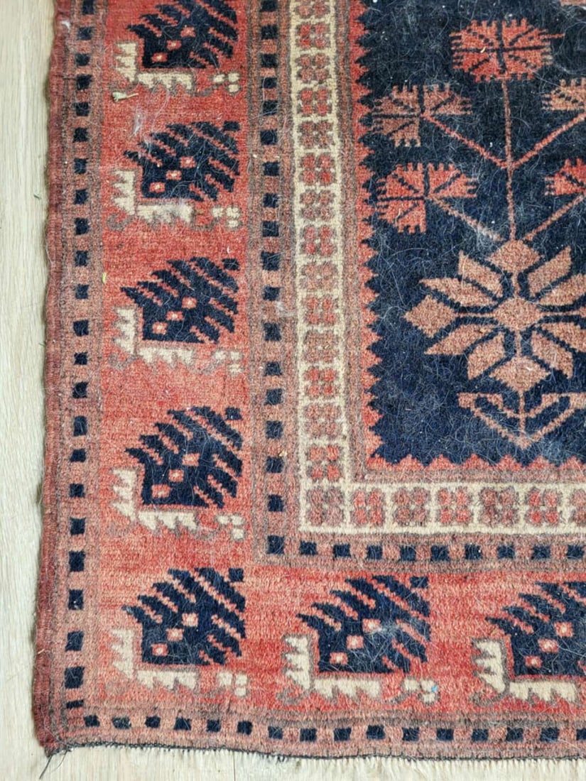vintage Turkish rug: vintage or antique Persian or Turkish (?) carpet with some fringe on either edge end and soft colors repeating border design and center with bookmark floral or flower accents