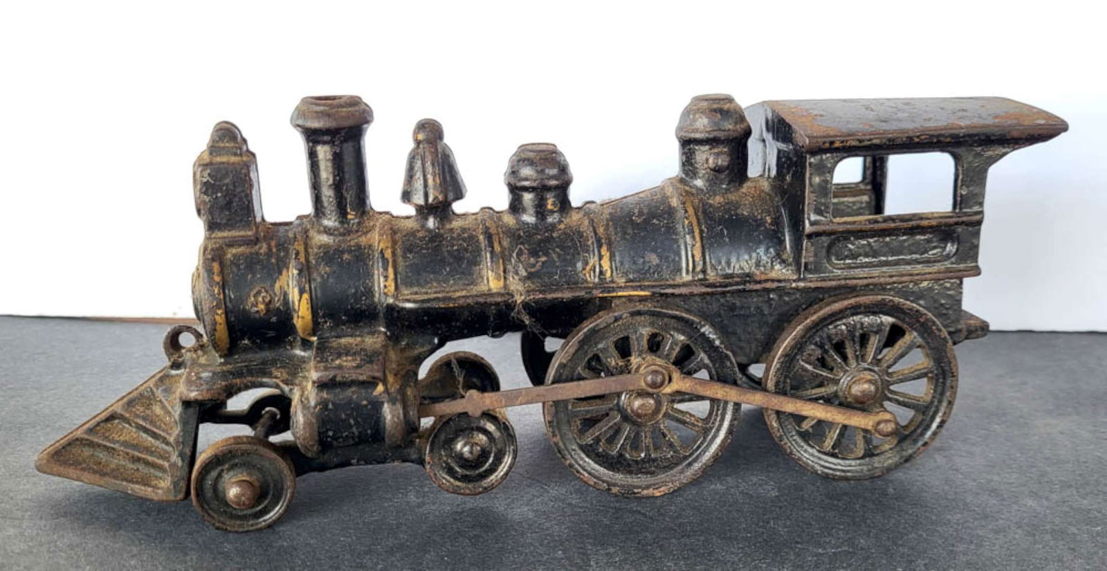 RARE late 1800s cast iron toy train engine: hard to find information on this toy, appears to be a late 1800's Wabash (?) toy train engine, note the unusually shaped front end and intact bars between the wheels, black with