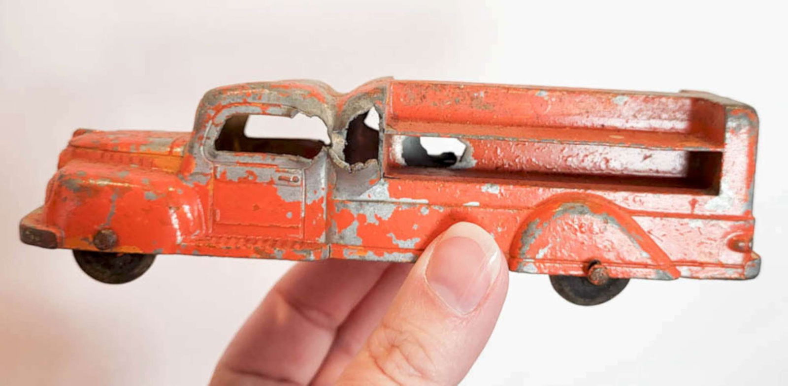 vintage orange toy truck: likely Tootsietoy but unmarked, original orange paint metal toy delivery truck on wheels