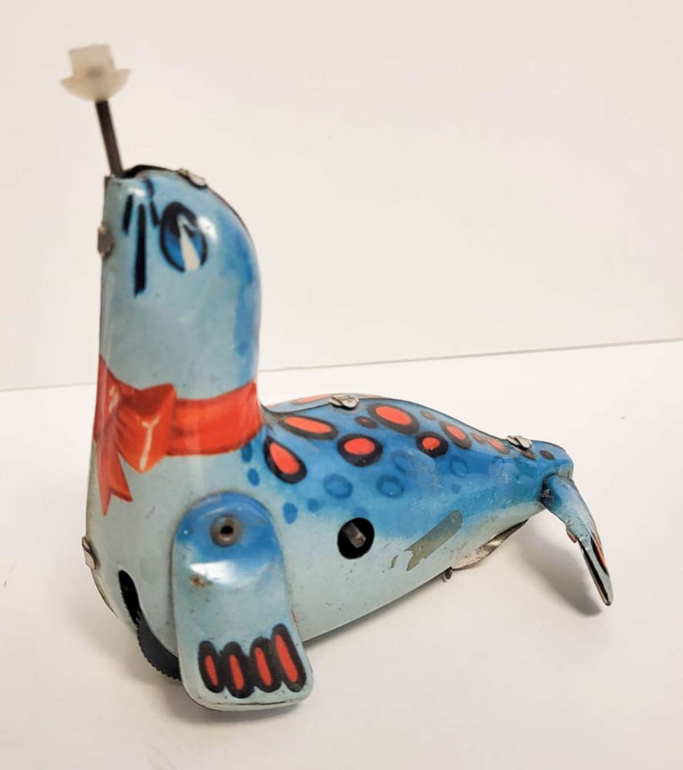 vintage tin wind-up toy animal: vintage or antique tin litho seal with bright blue color, no key and missing ball balancing on his nose