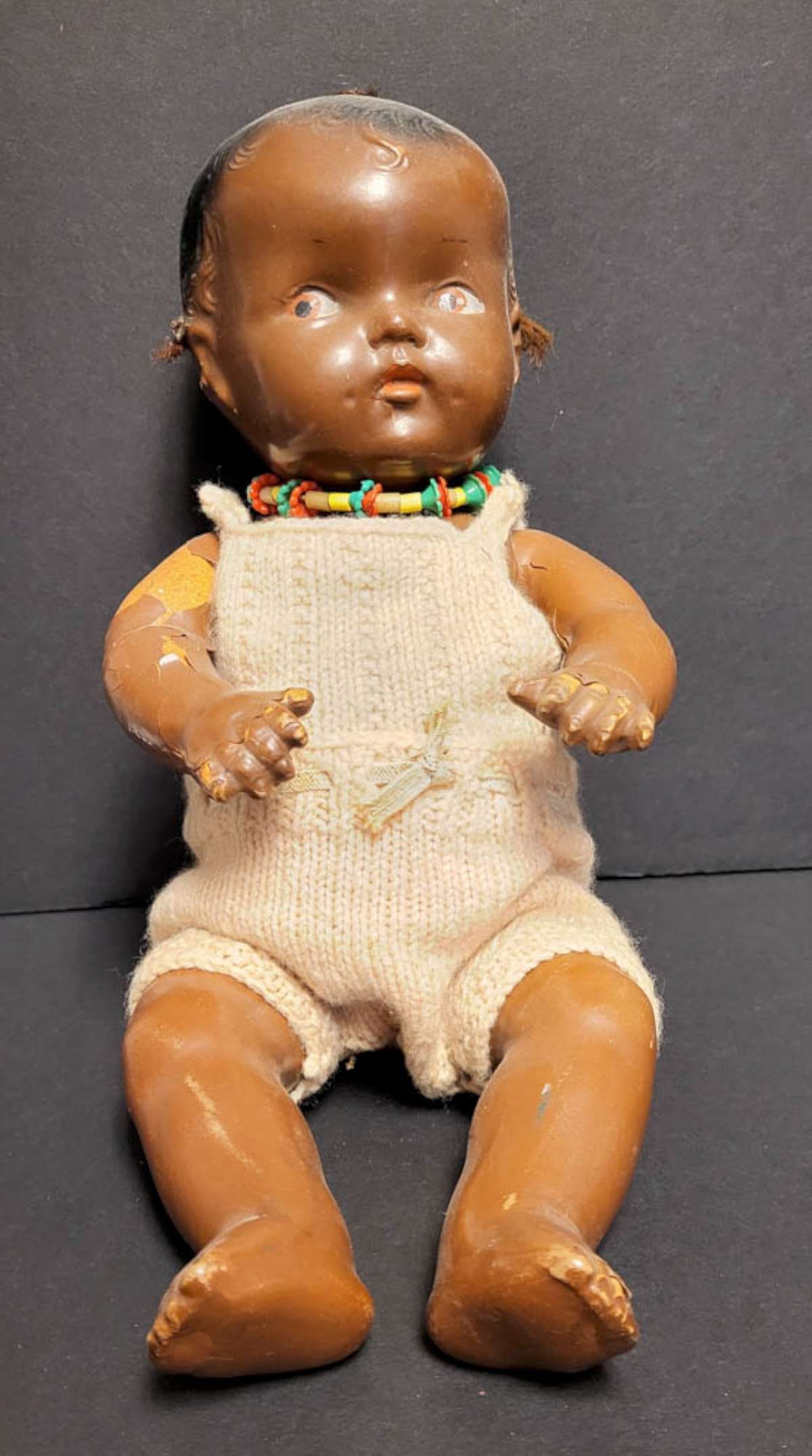 antique African American composition doll: vintage or antique Black Americana baby girl doll with cute knit outfit and necklace, no maker's mark but looks like a Goldberger