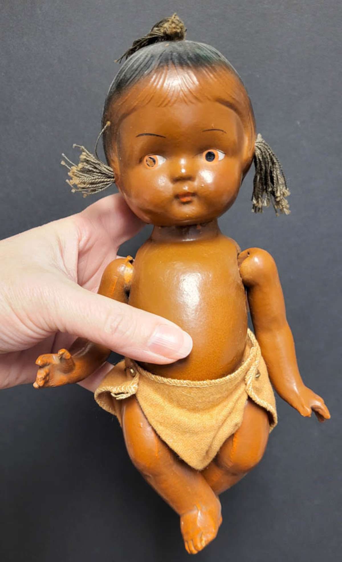 antique African American composition doll: vintage or antique Black Americana baby girl doll with loincloth string hair, no maker's mark but looks like a Goldberger