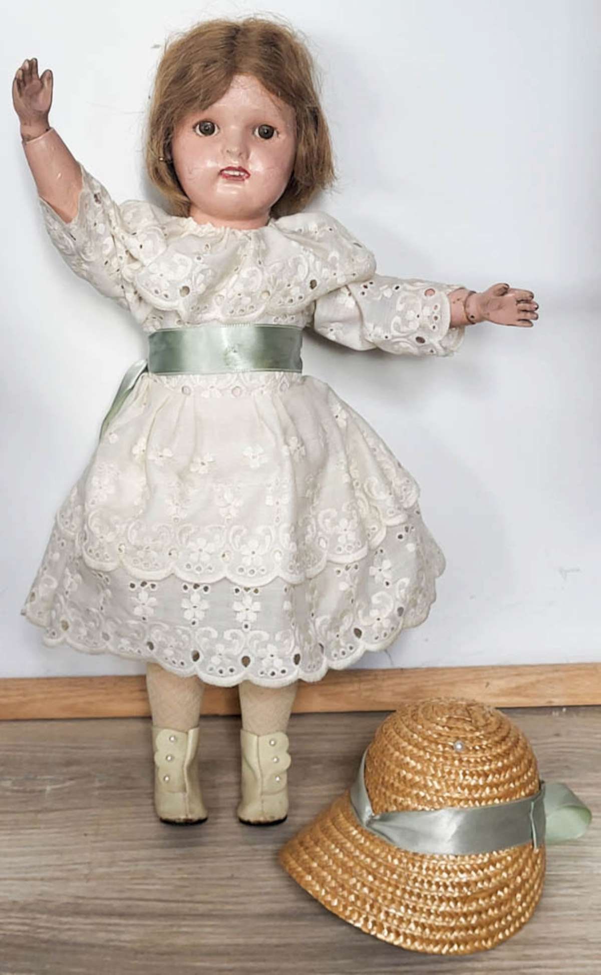antique wooden Schoenhut girl doll: made by the Albert Schoenhut and Company from Philadelphia Pennsylvania, wooden head with hand painted eyes and features and open mouth with teeth showing, attached (looks like an
