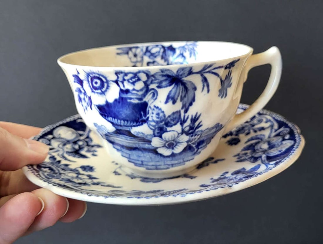 vintage Royal Doulton English porcelain set: handled cup and matching saucer with white background and blue floral or flower and fruit design with Apples and Pears, marked as shown Made in England Pomeroy Produced from the Original Davenpo