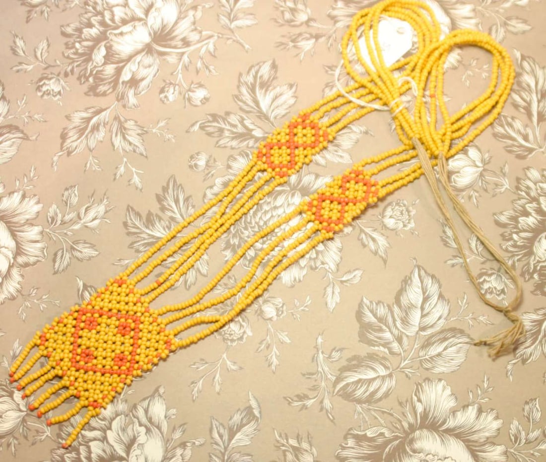 vintage estate jewelry: Bedouin necklace: according to the consignor, this necklace was purchased in the early 1970's from a Bedouin, yellow and orange tiny seed or trade bead woven bib necklace with twine closureabout 29&quo