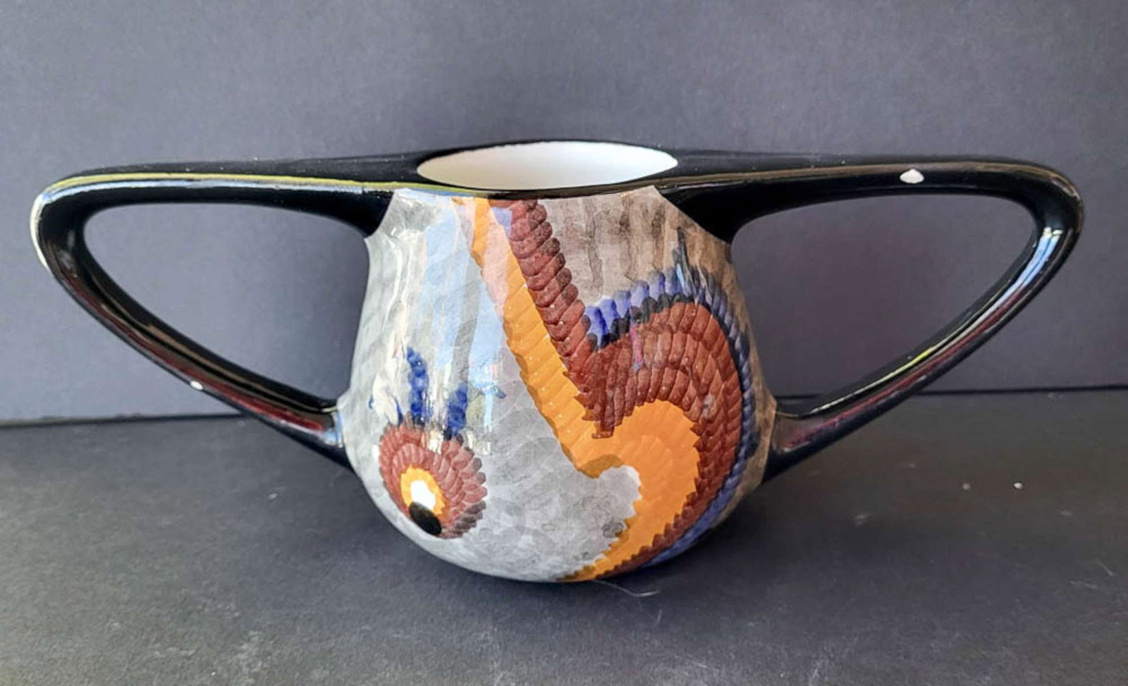 vintage Eva Zeisel Art Deco vase: double handled "Gobelin" by Hungarian born designer Eva Zeisel (1906-2011) with a black background and organic looking vibrantly colored shapes, marked as shown underneath Made in Germ