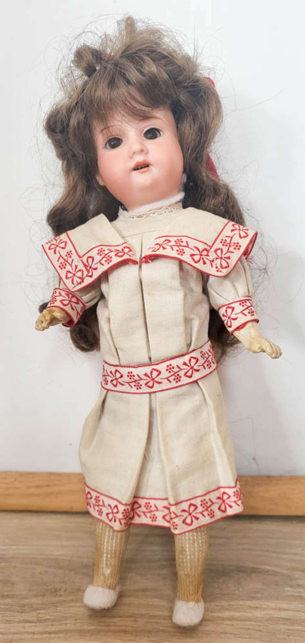 antique Armand Marseille porcelain head girl doll: cute small bisque or porcelain head doll with long haired brunette wig, brown sleepy eyes, open mouth with teeth showing and wooden or composite arms and legs and nice vintage dress with r