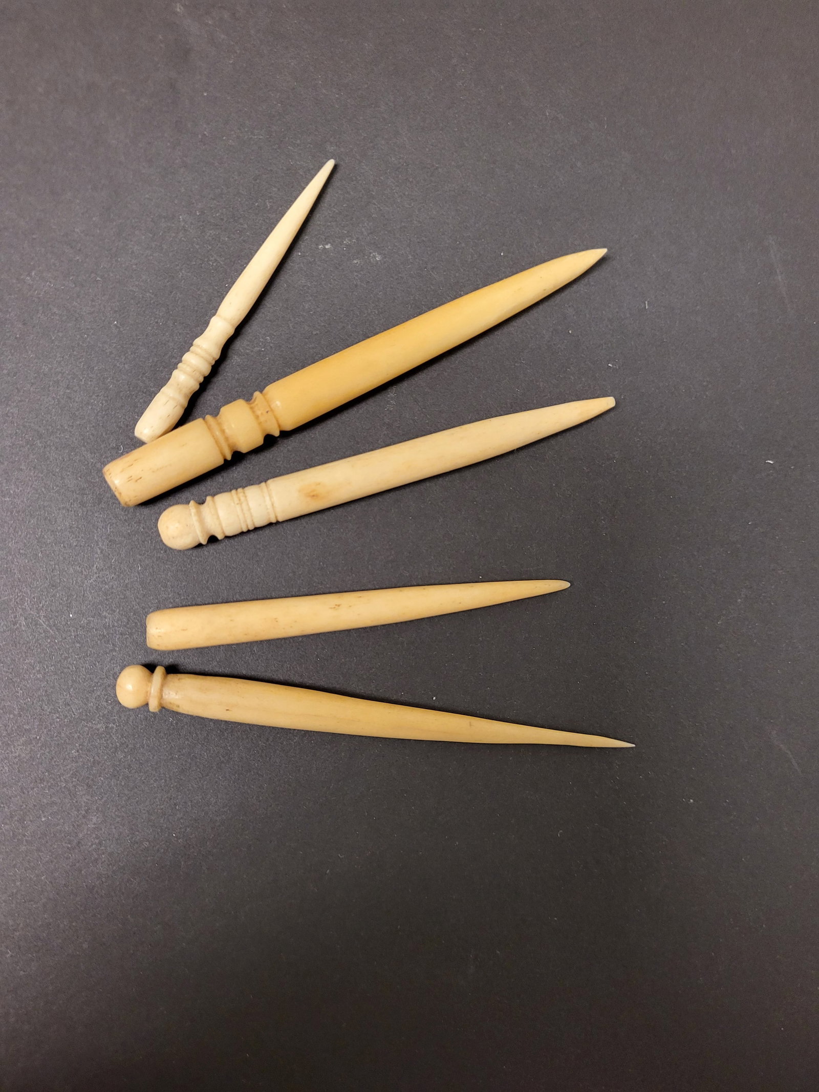antique bone sewing implement tools: set or lot of 5 carved bone antique Edwardian or Victorian Era late 1800's awls (sailor made tools for mending rope) or bodkins (used for pulling ribbon through a hem or making holes in fabric)