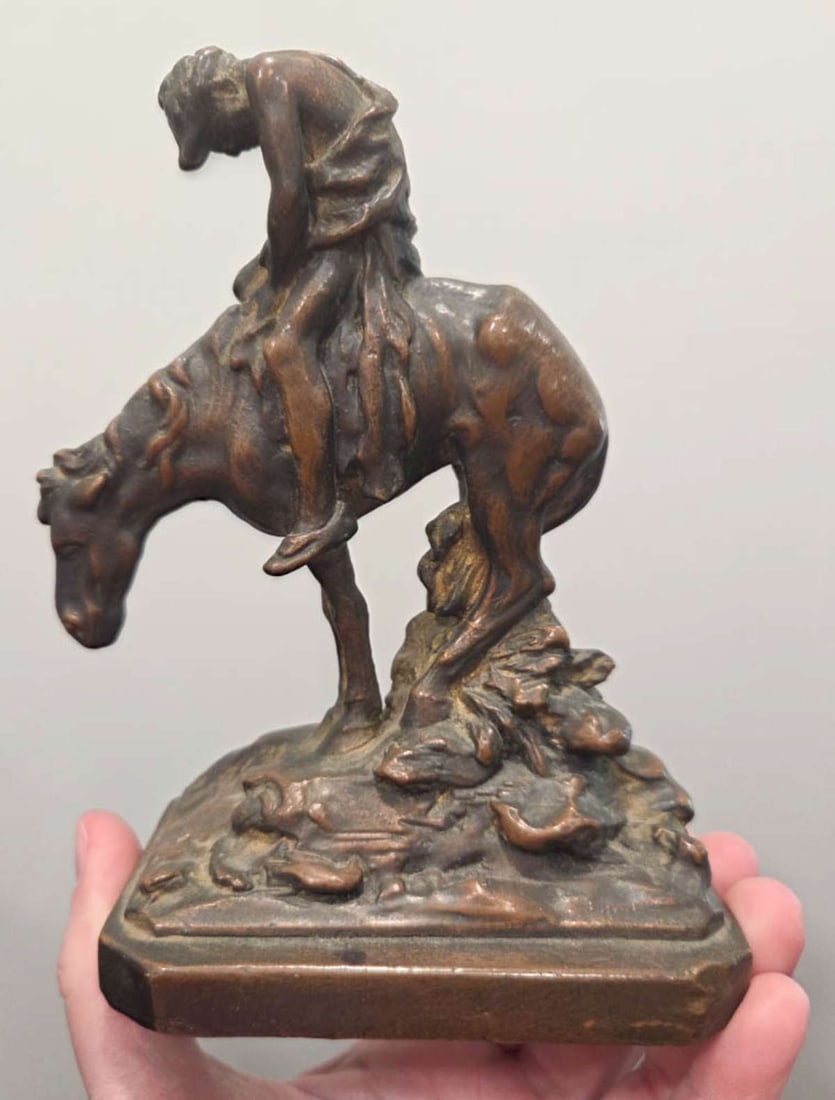 vintage man on horseback single metal bookend: vintage doorstop or single bookend modeled after James Earle Fraser's "End of the Trail" and unmarked and likely bronze (magnet doesn't stick to it)