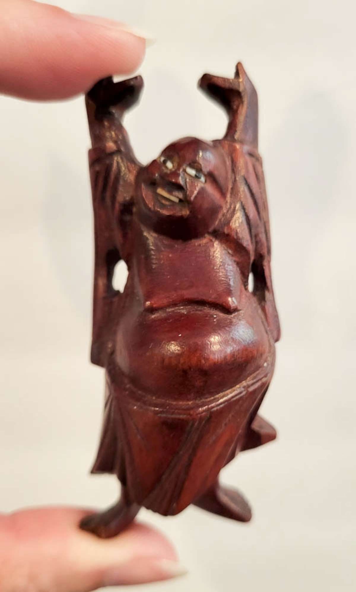 vintage Asian carved statue of a Buddha: vintage or antique figural carved wooden statue in dark reddish wood (Rosewood?) with glass eyes, depicting a Buddha with his arms outstretched, unsigned