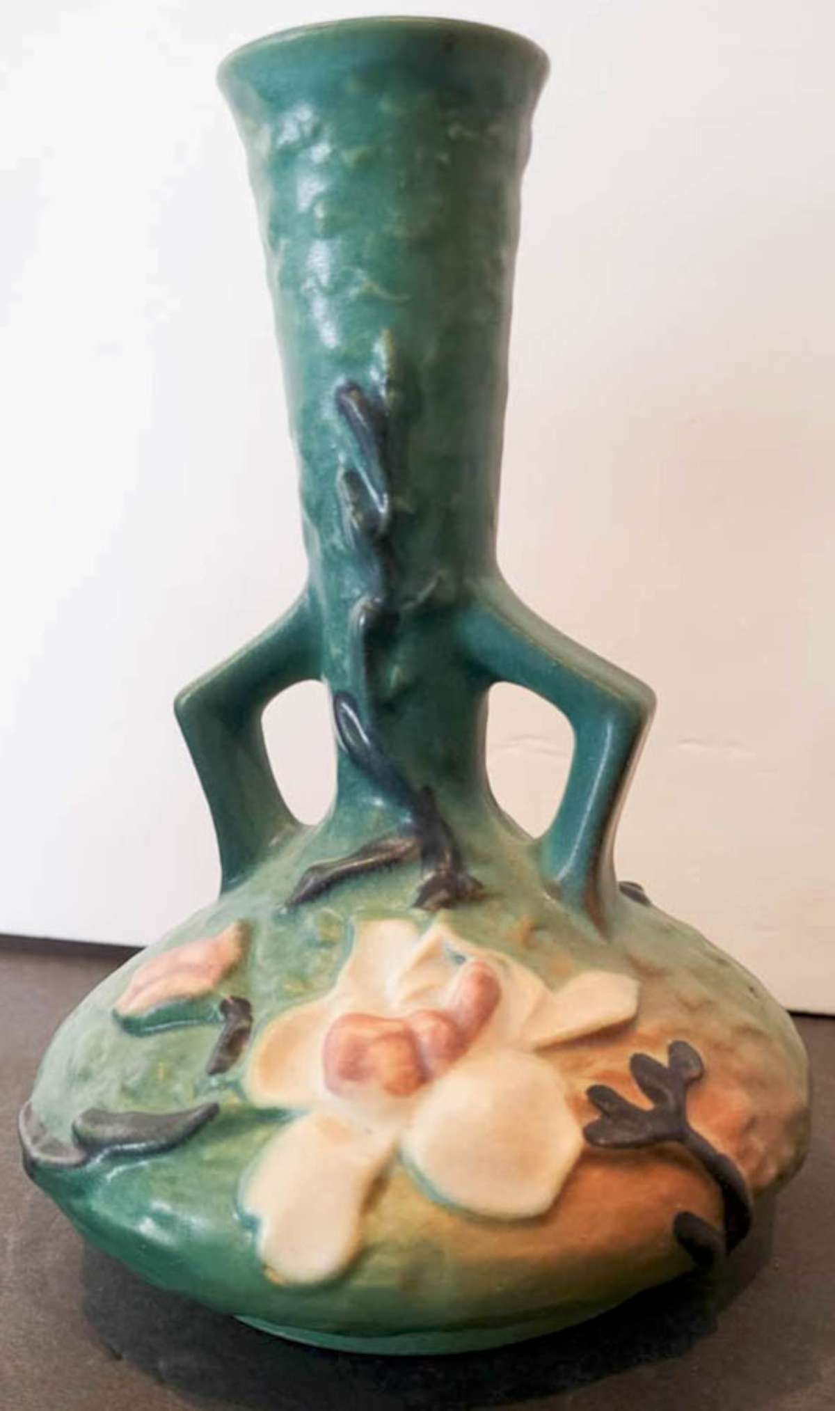 antique Roseville pottery vase: matte green vintage or antique marked Roseville pottery long neck vase with double handles and white and pink Magnolia flower design, marked underneath as shown Roseville USA and 179-7