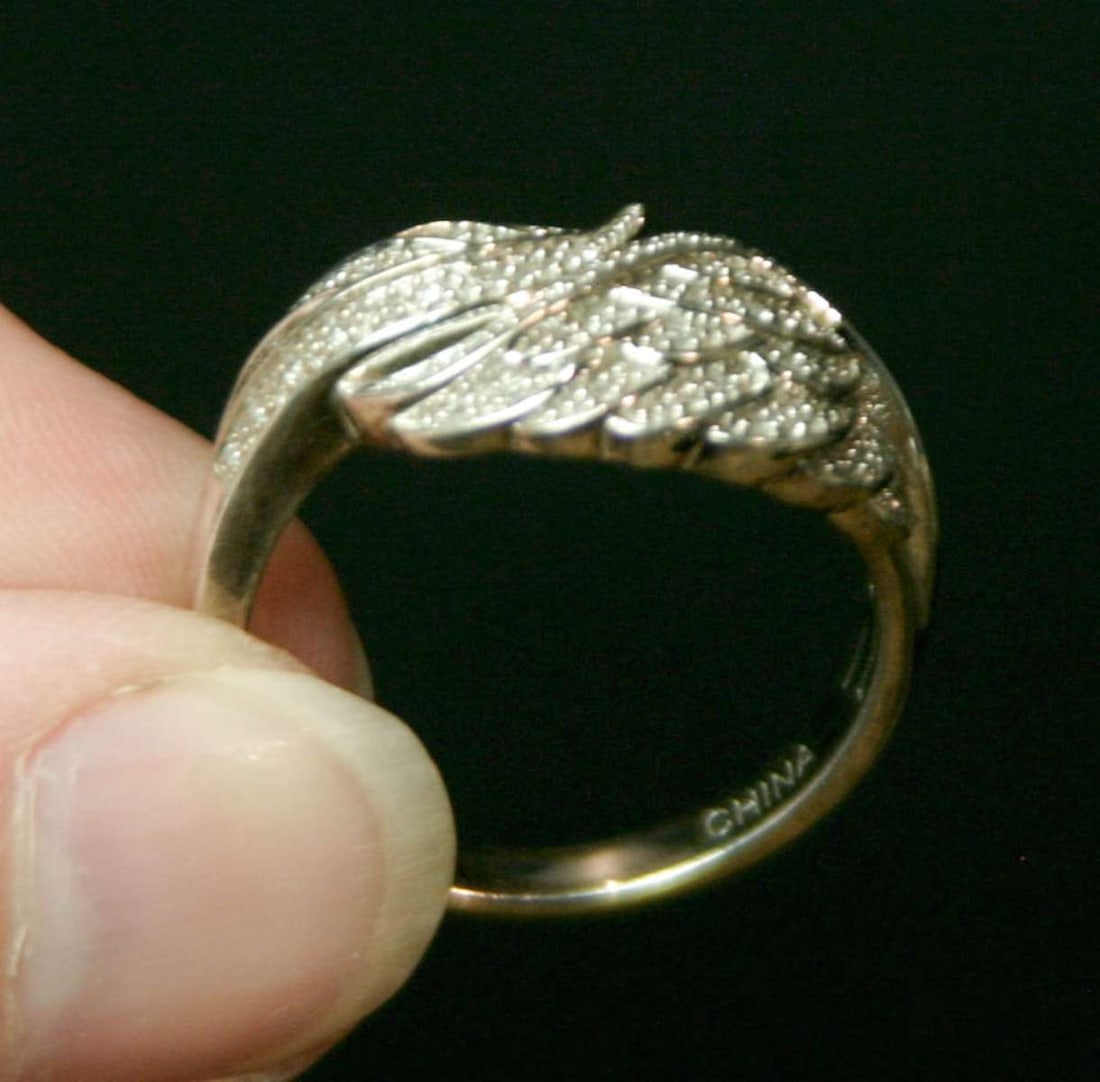 vintage estate jewelry: silver diamond ring: marked 925 for Sterling silver and maker's mark EA as shown, encrusted with tiny chip diamonds, some of which have inclusions (see UV blacklight pictures provided) about a ring size 1