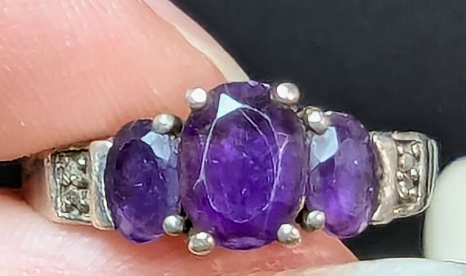vintage estate jewelry: Amethyst ring: marked 925 for Sterling silver vintage or antique ring with scrollwork design on the band and 3 large cut purple Amethyst stones about a ring size 8