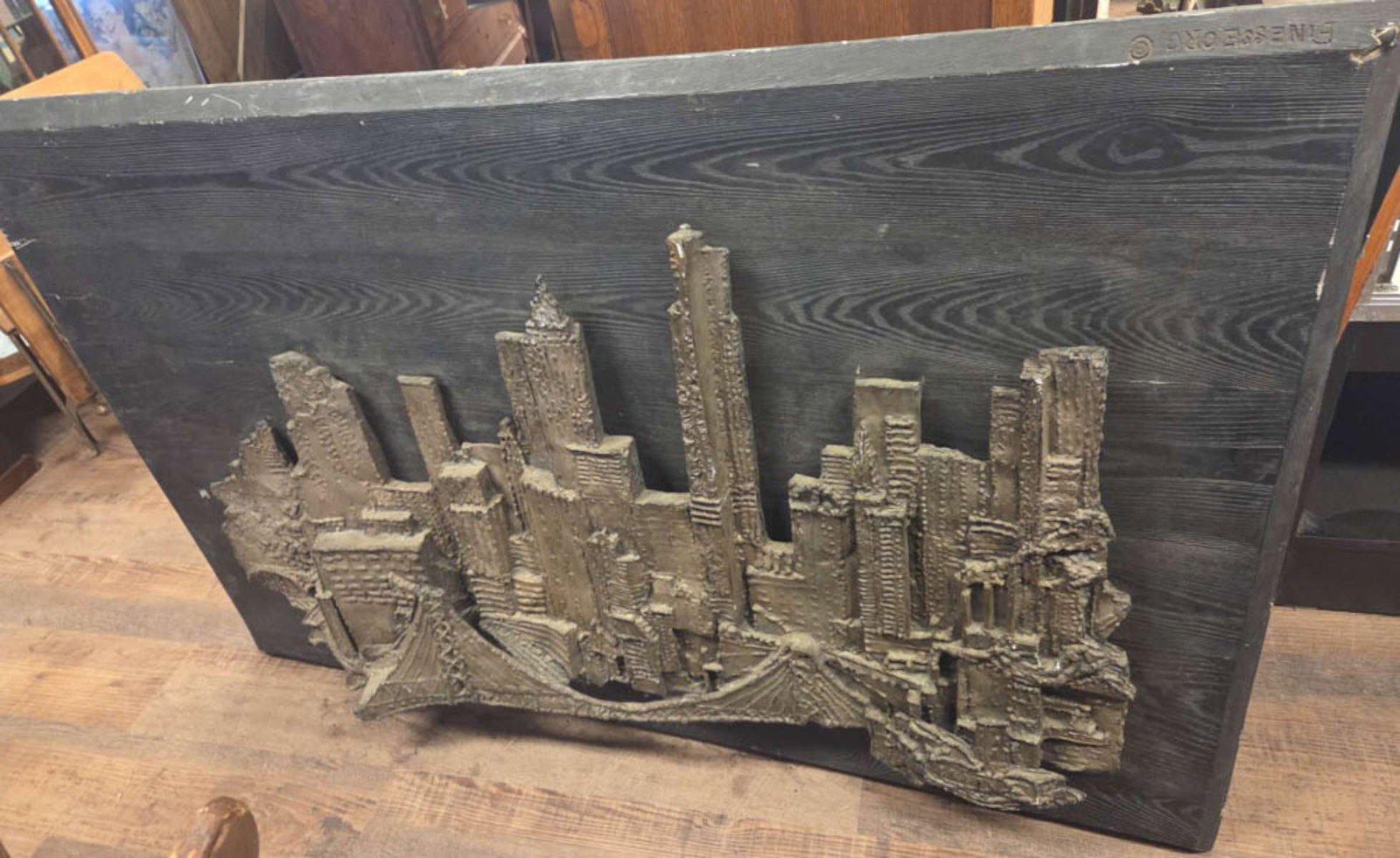 HUGE vintage Brutalist cityscape artwork NYC: unusual very large wall hung fiberglass or composite black painted background made to look like wood, marked Finesse Org with Brutalist style cut metal 3-D raised skyline design of tall skyscrap