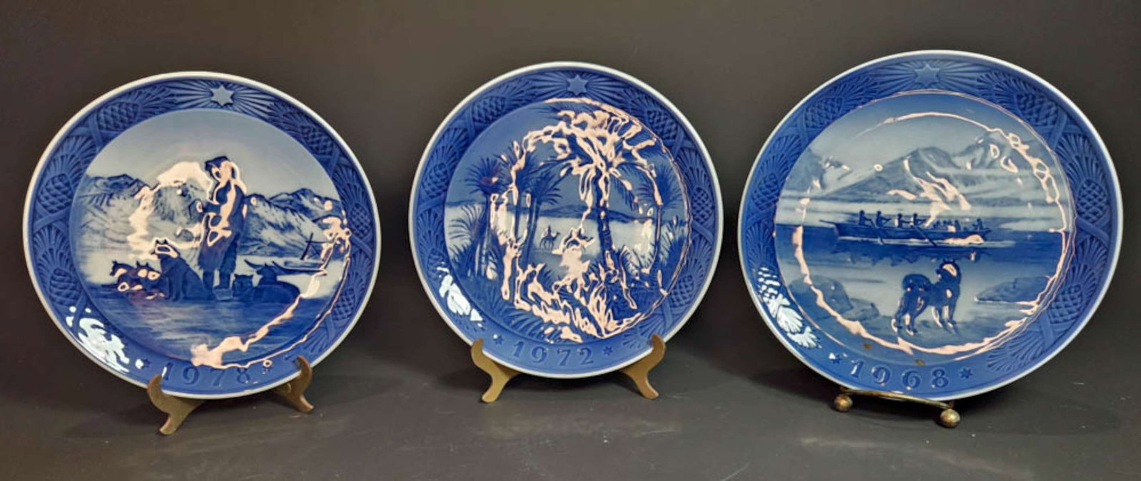THREE vintage Danish Royal Copenhagen Christmas plates: set or lot of 3 blue and white wall hung plates, marked as shown, titled 1978 Greenland Scenery, 1972 In The Desert and 1968 The Last Umiak
