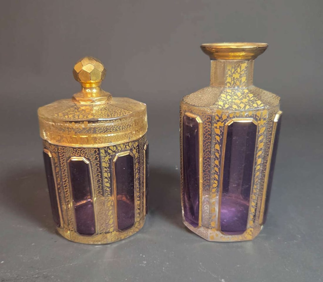 2-piece antique Moser glass vanity set: antique pair of glass dresser or vanity bottles, one without the stopper and the other with a lid, likely for tonic and cotton balls, purple and gilt design all around, unmarked but likely Moser