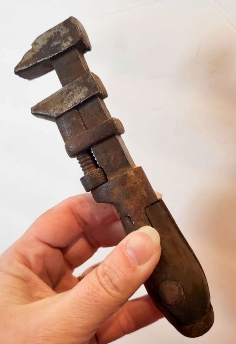 vintage or antique hand tool: small but heavy pipe fitters' monkey wrench tool with original wooden handle