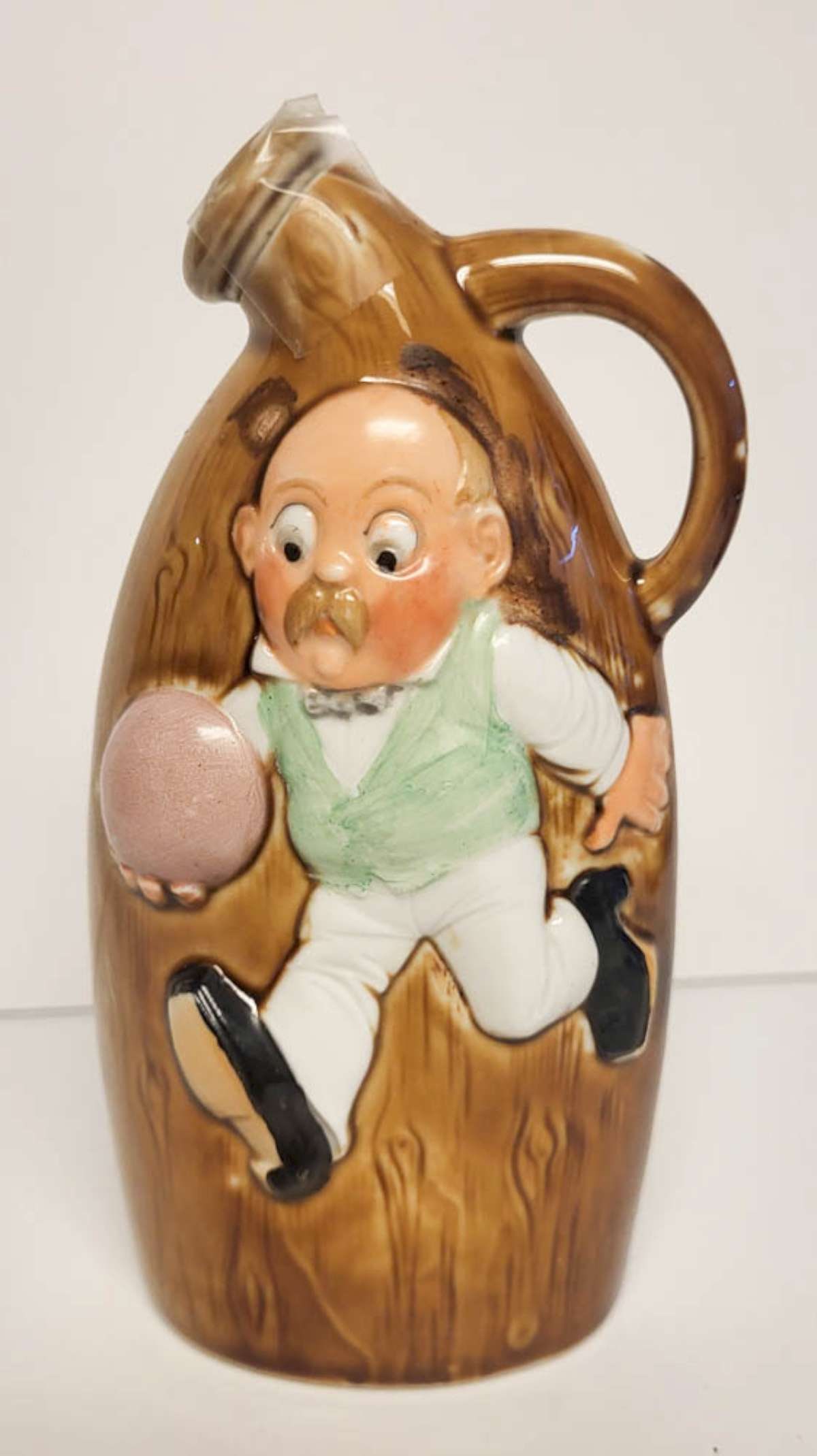 vintage Redware figural liquor bottle: vintage or antique pottery glazed liquor bottle marked Sample Made in Germany and with caricature of an English man running with a Rugby ball and cork stopper, back with remnants of the original
