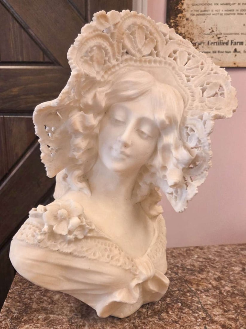 antique carved marble bust of a lady: young woman with "lace" wide brimmed hat and demure look on her face, illegibly signed on the back (likely Italian made) about 15 3/4" high by 11" wide by 9" deep