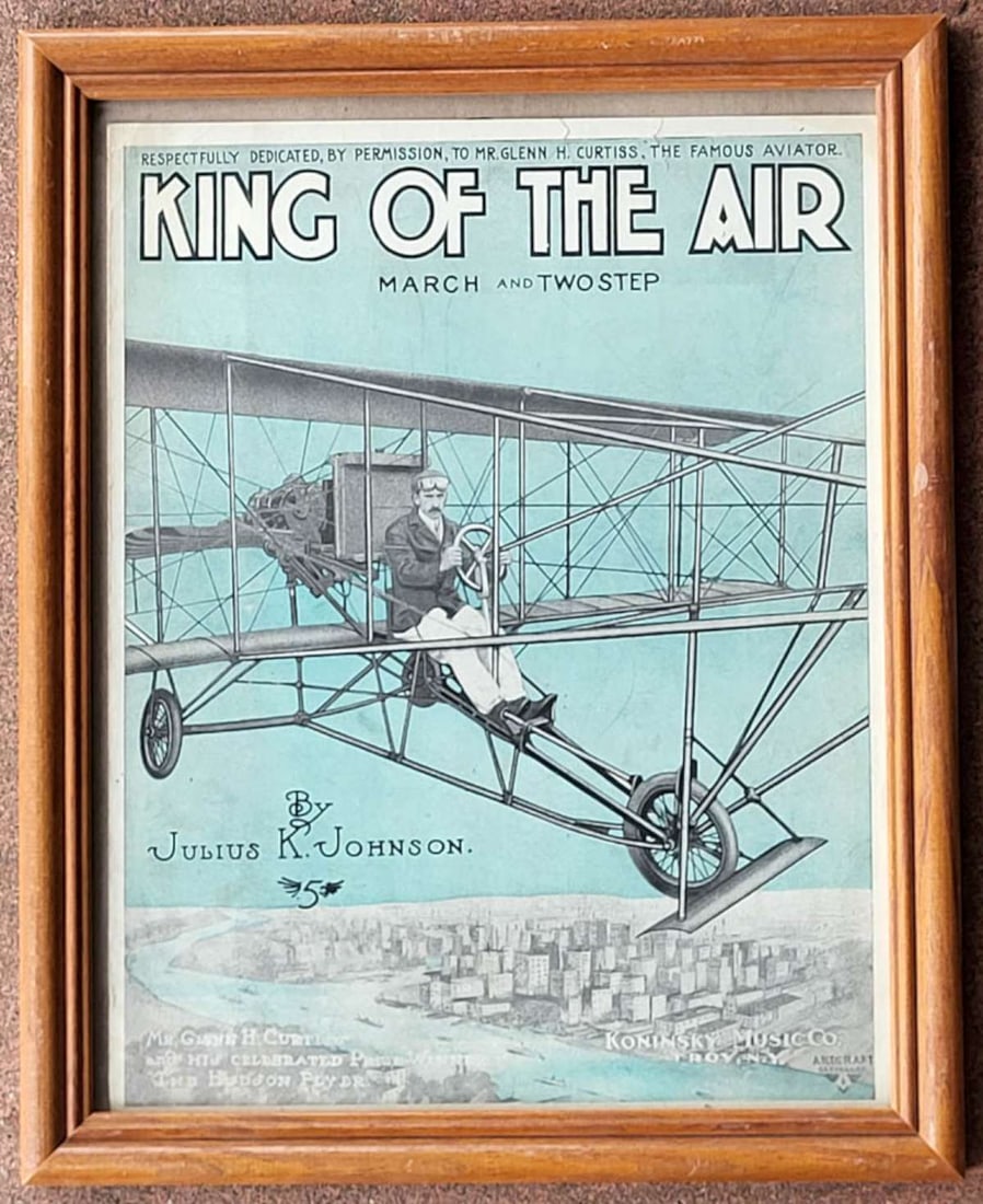antique Early Aviation framed sheetmusic: vintage oak wooden frame with antique sheet music booklet with beautiful color illustration of Glenn Curtiss in an airplane named The Hudson Flyer, music titled King of the Air by Julius K. John