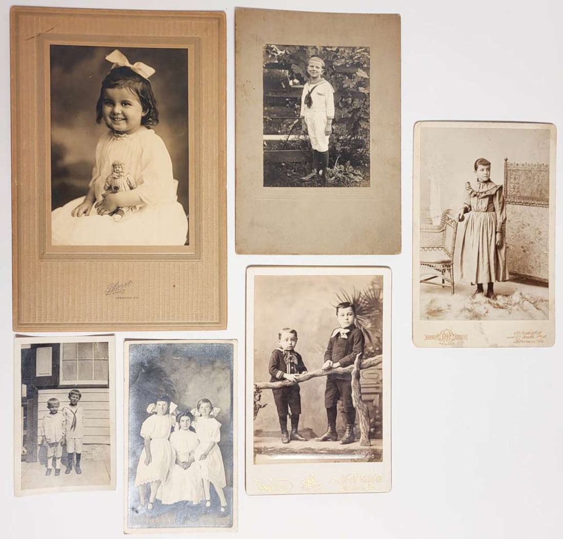 vintage portrait photographs featuring children: set or lot of five vintage and antique black and white and sepia toned photographs and one postcard, depicting kids (boys and girls) posing for the camera, photographers include Blazier St