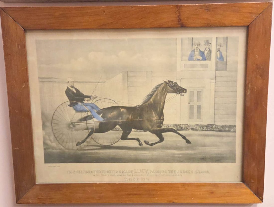 antique horse rider and sulky framed print: late 1800's antique hand tinted engraving by Curries and Ives titled The Celebrated Trotting Mare Lucy Passing the Judges Stand, depicting a man on a sulky racing a horse, text reads 