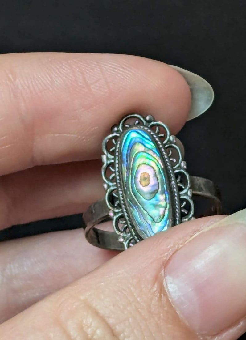 vintage estate jewelry: Abalone silver ring: marked 925 for Sterling silver ring with maker's mark as shown and large oval center Abalone shell with filigree and ball rim design about a ring size 9