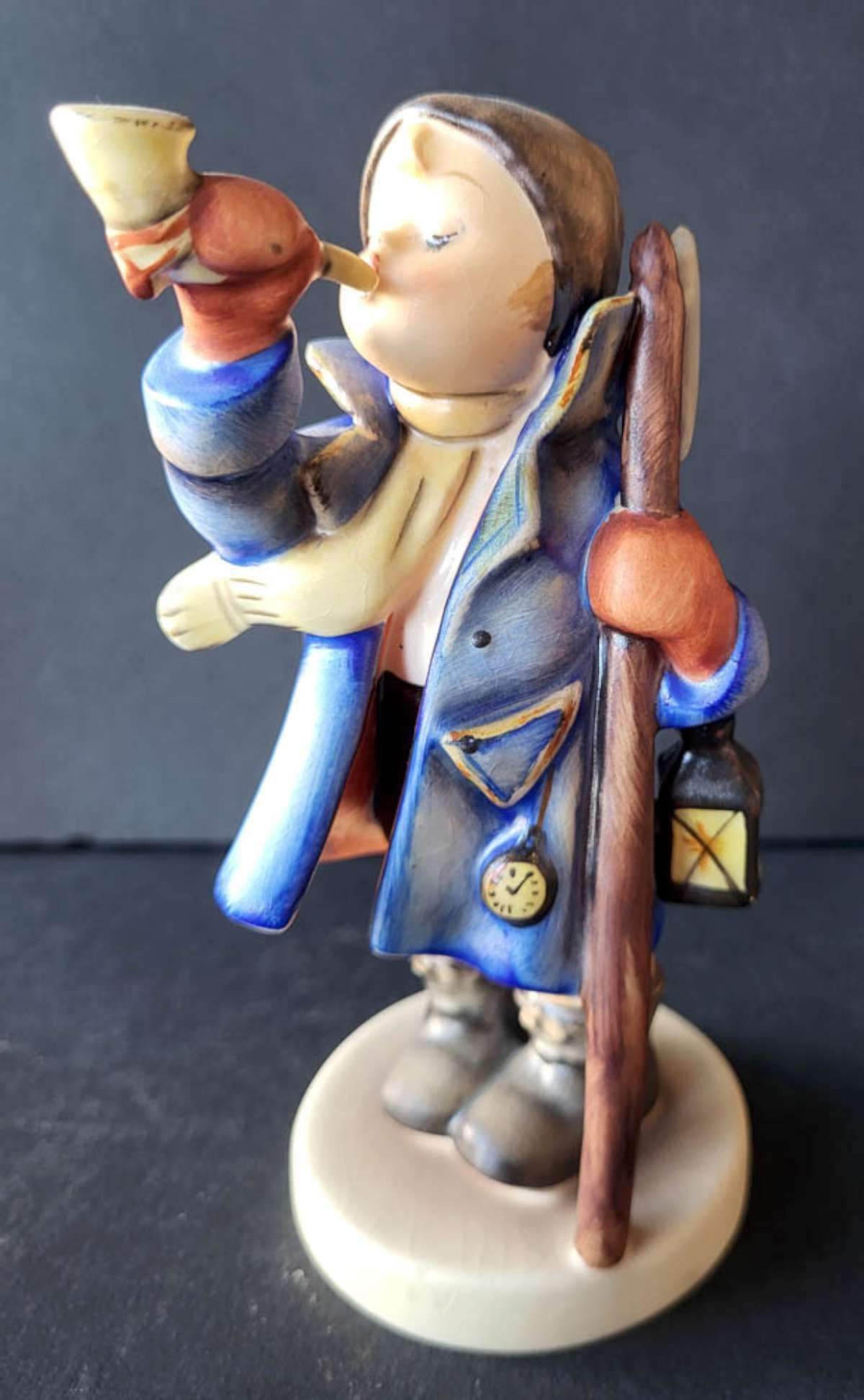 adorable Hummel boy statue by Goebel: vintage marked Goebel West Germany figural Hummel figurine titled Hear Ye Hear Ye numbered 34 (?) as shown, shaped like a boy in a blue coat blowing a horn or other musical instrument 5 1/8"