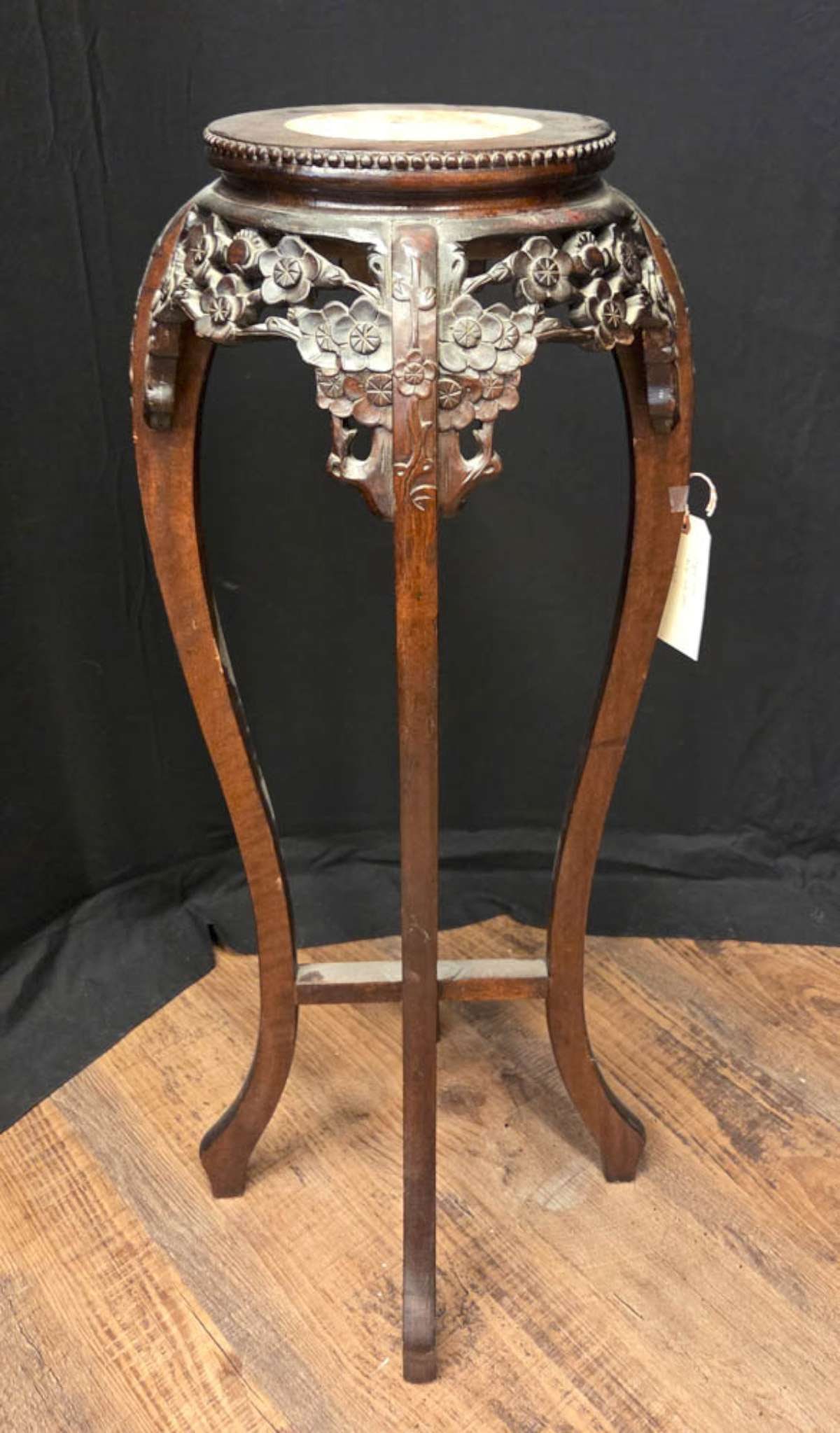 antique carved wooden Asian stand with marble top: antique Chinese carved wooden tall plant stand or lamp table, with floral Lotus or Dogwood flower design around the rim and in the center of the legs, inset marble round top