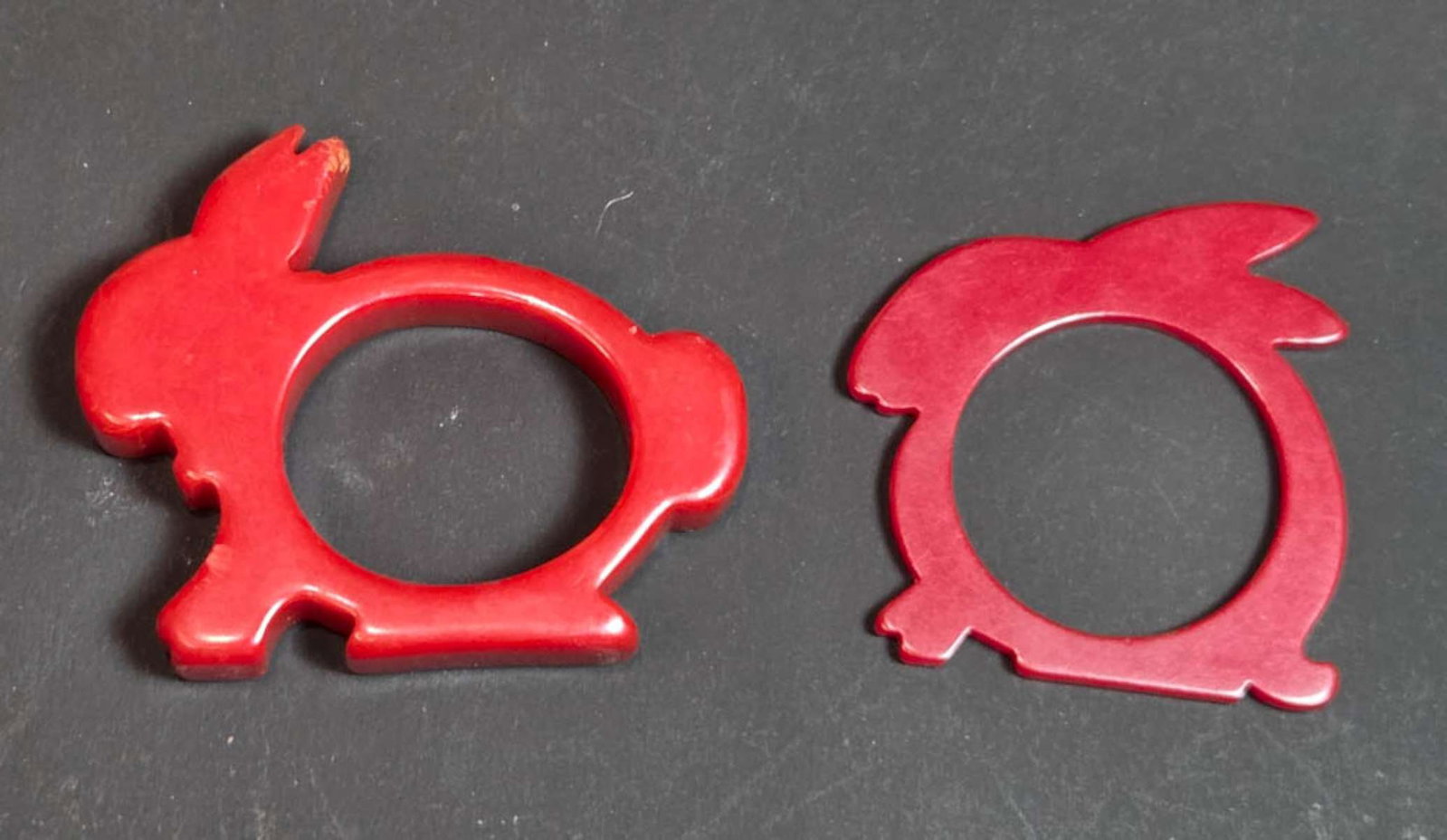 PAIR vintage Bakelite animal shaped napkin rings: set or lot of two vintage or antique Art Deco period red Bakelite napkin holders, one chunky rabbit, one skinny bunny