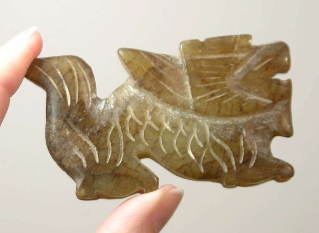 vintage or antique Asian Jade amulet: likely Chinese Jade or other stone pendant or large amulet depicting a whole body dog or tiger figure in mottled green and brown tones, last picture shows piece held in front of a bright light (