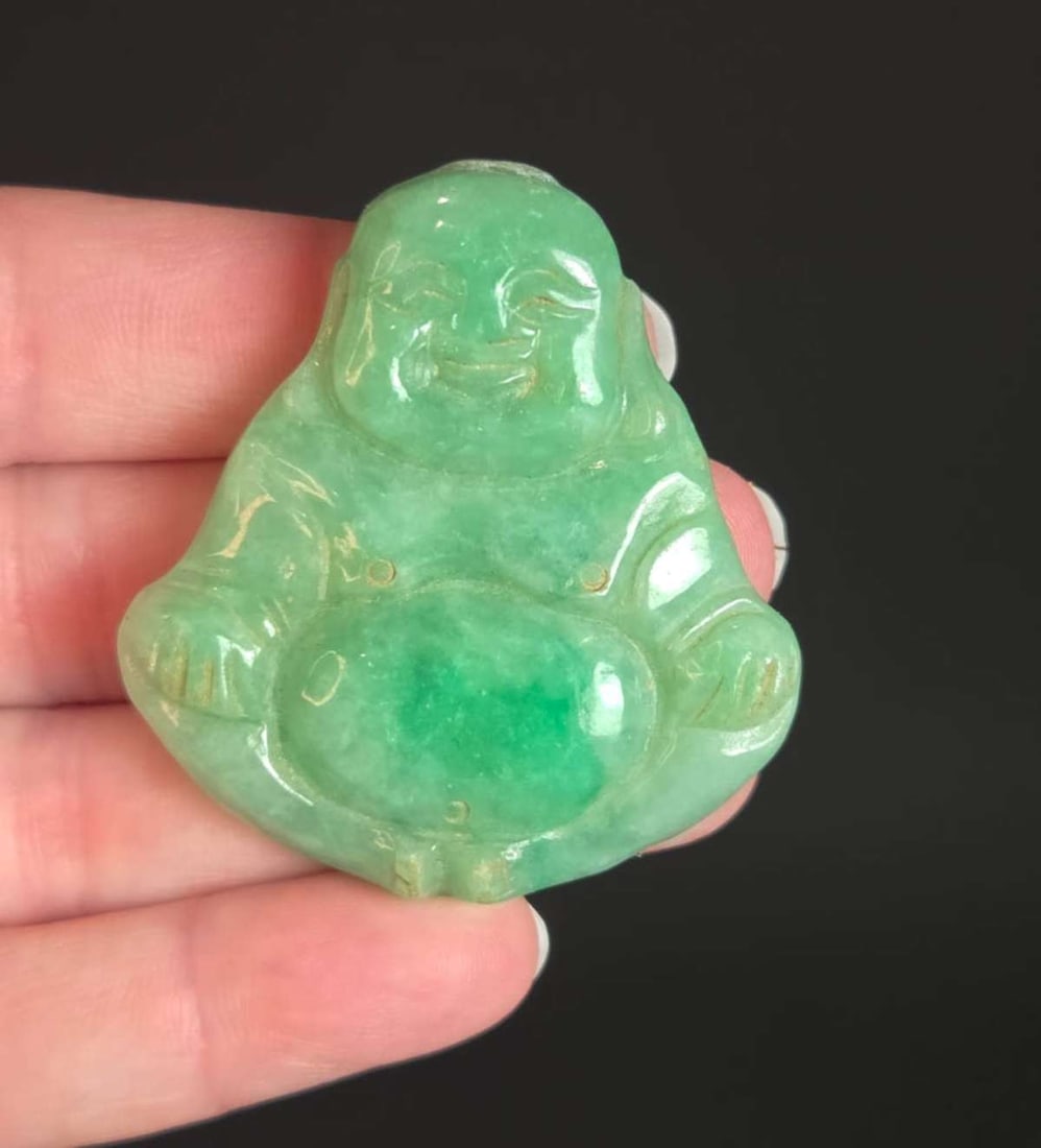 vintage or antique Asian Jade amulet: likely Chinese Jade or other stone amulet or good luck charm depicting a full body Buddha or other Deity sitting in a lotus position (meditating?), in mottled green and white tones with painted 