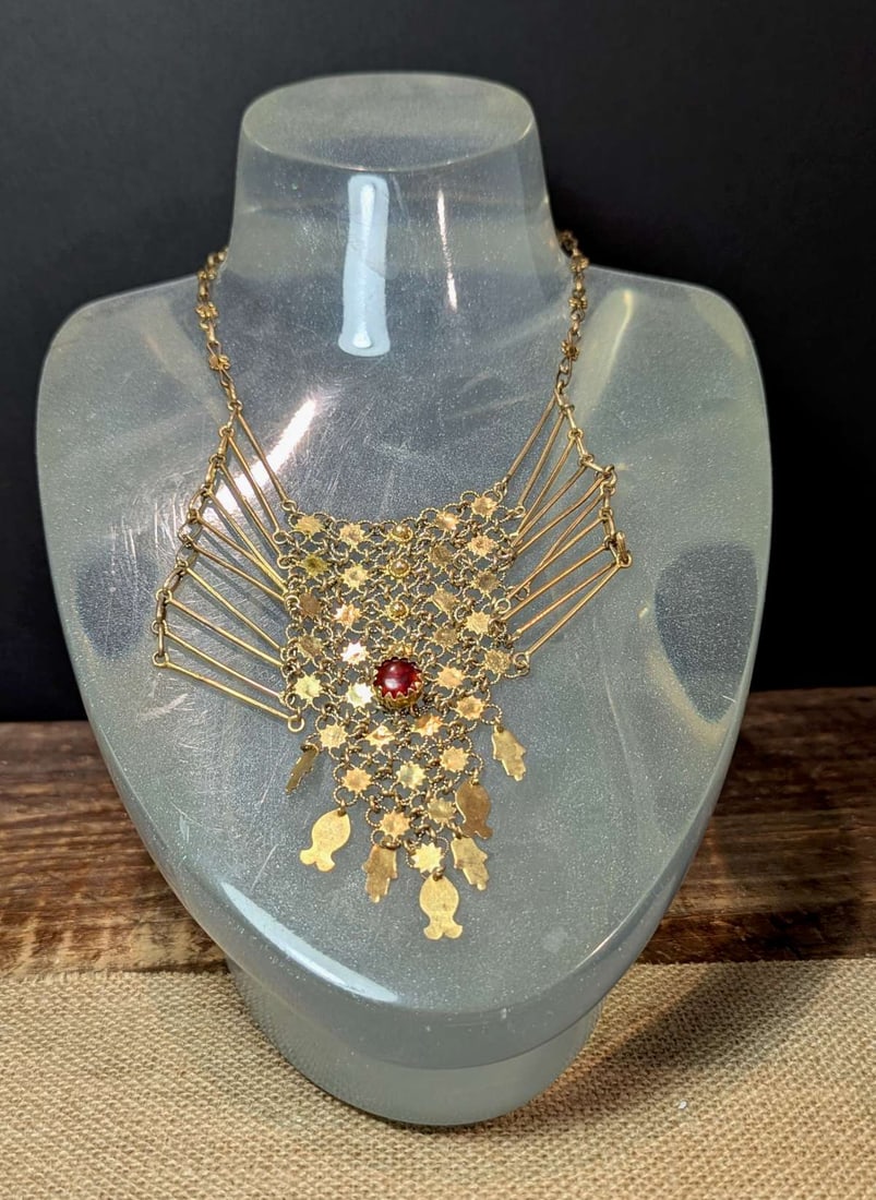 vintage estate jewelry: Egyptian Revival necklace: vintage artisan made cascading or dangly bib style gold toned metal necklace with center chainmail design and red cabochon stone, hook closure and what an unusual conversation piece about 16&quo