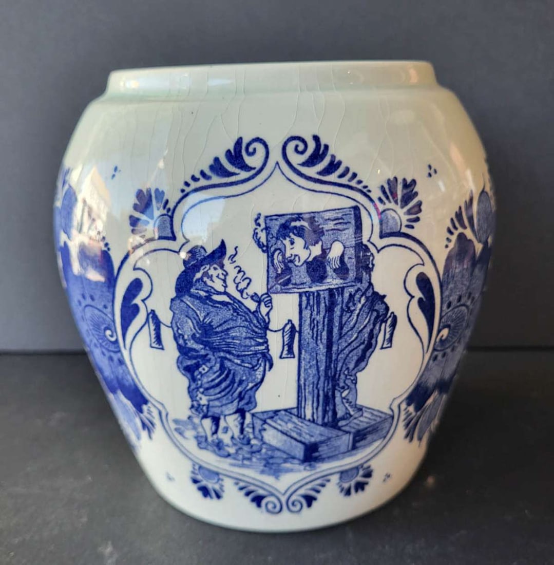 vintage Delft porcelain tobacco jar or vase: vintage pottery or porcelain bulbous pot or tobacco jar with text Van Rossem's Toeback Anno 1750 and with a depiction on the front of a man chained to a stockade and another man smoking a pipe wa