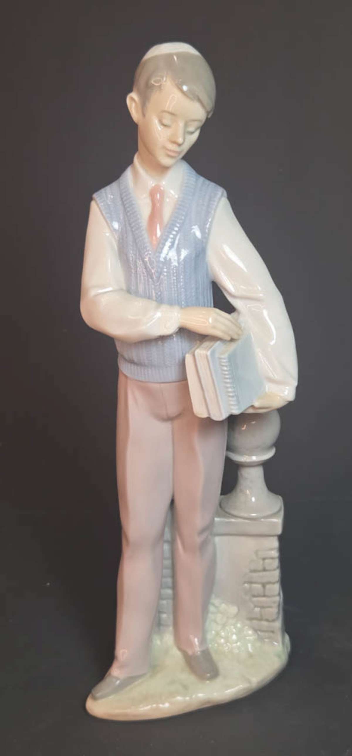 vintage Lladro porcelain statue boy with books: vintage porcelain blue, white and beige colored statue, named School Days or Hebrew Scholar, depicting a young man holding a stack of books, marked as shown underneath Lladro H