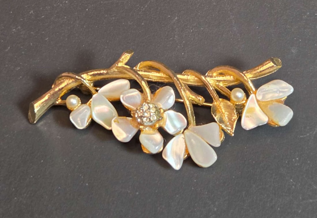 vintage estate jewelry: Capri pin brooch: vintage Mid Century Modern botanical line by Capri, marked as shown, gold toned pin brooch with MOP or mother-of-pearl, faux pearl and clear cut rhinestones, shaped like flower
