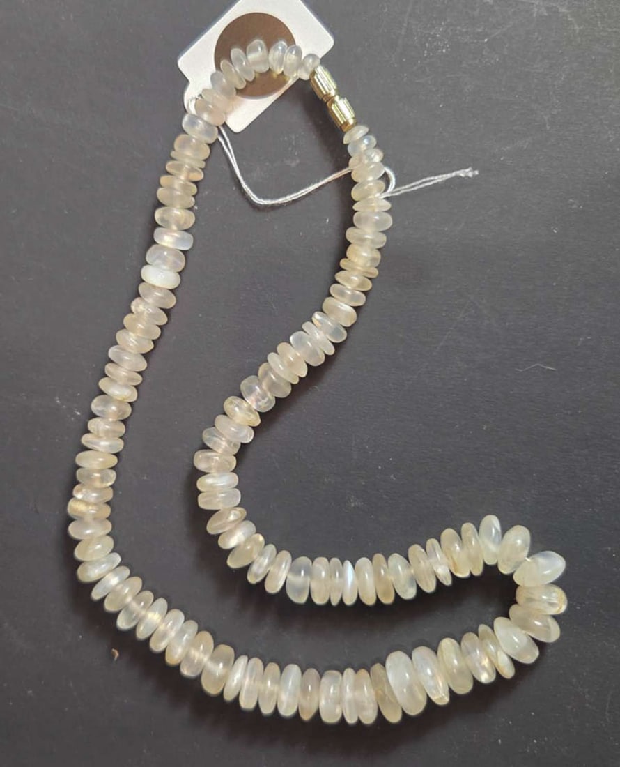 vintage estate jewelry: Quartz necklace: vintage gold toned twist closure necklace with graduating sized white or translucent Quartz disc shaped beads about 17" long