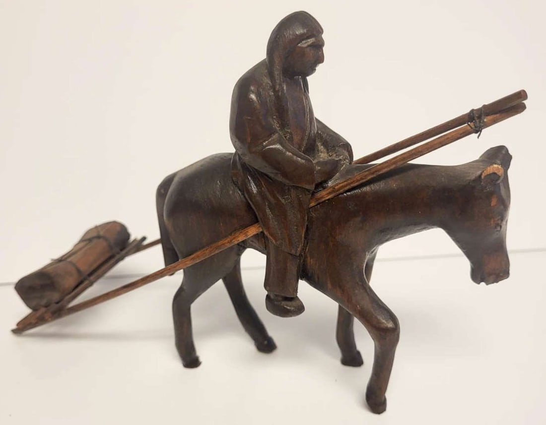 vintage carved Native American Indian sculpture: vintage carved wooden statue depicting a Native American on horse back and trailing a travois (Great Plains sled used to transport goods), no maker's mark height about 6" and about 9 1