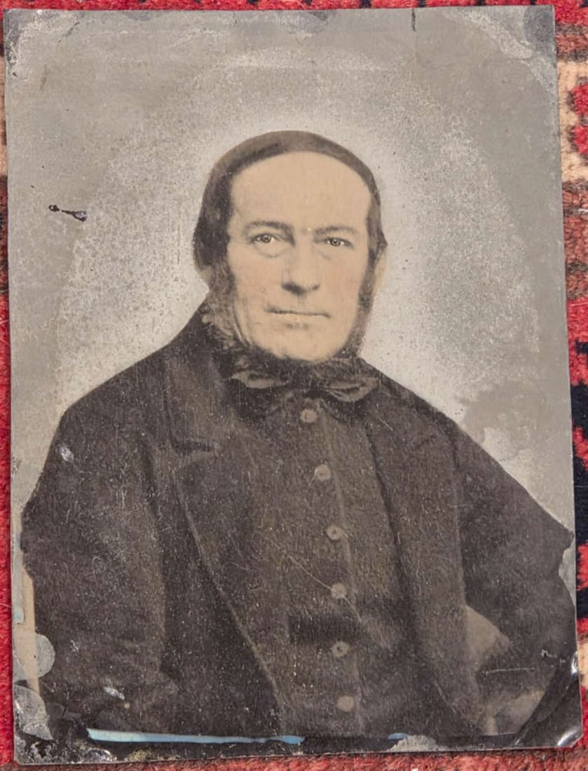 large antique tintype photograph: unframed large sized hand tinted photograph on tin of a gentleman with an almost smile on his face 8 1/2" high by 6 1/2" wide