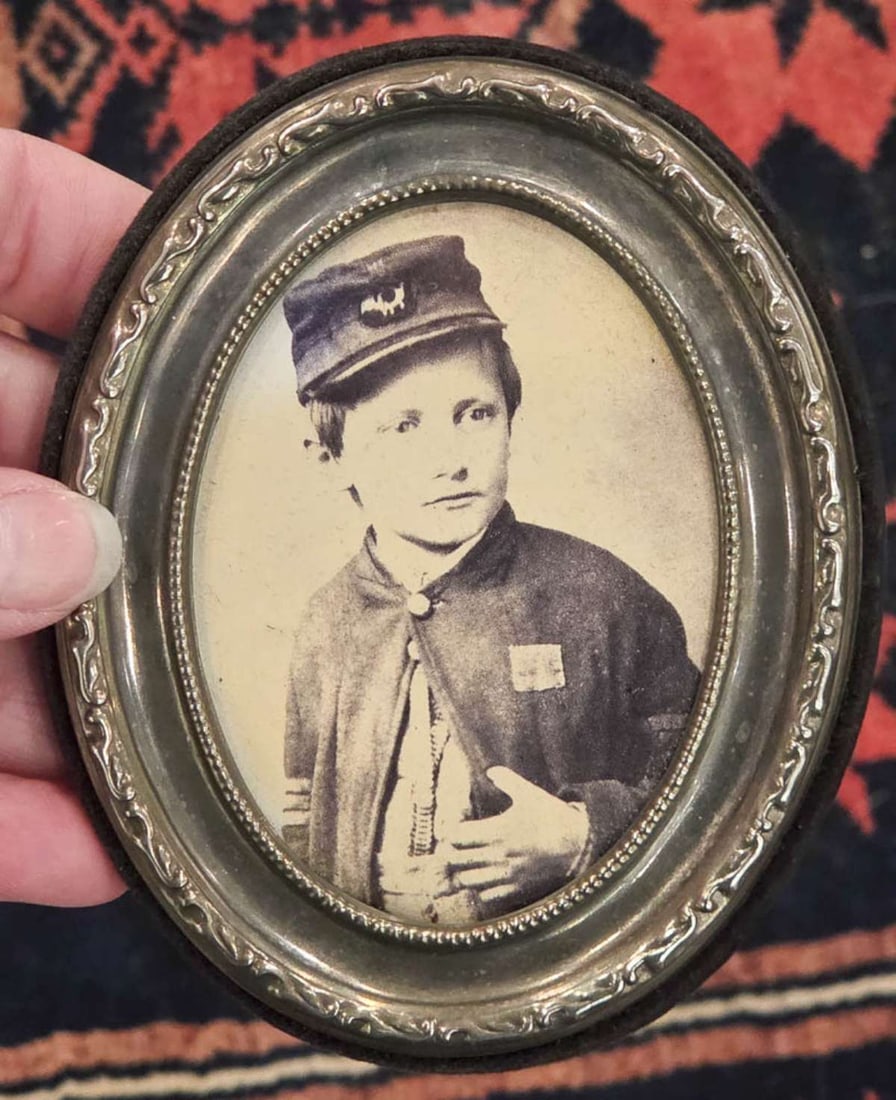 print of a Civil War era photograph of John Lincoln Clem: oval silver plated miniature picture frame with print John Lincoln Clem, the youngest soldier to serve in the Union Army (more info below) frame 4 1/2" high by 3 1/2" wide Info from on