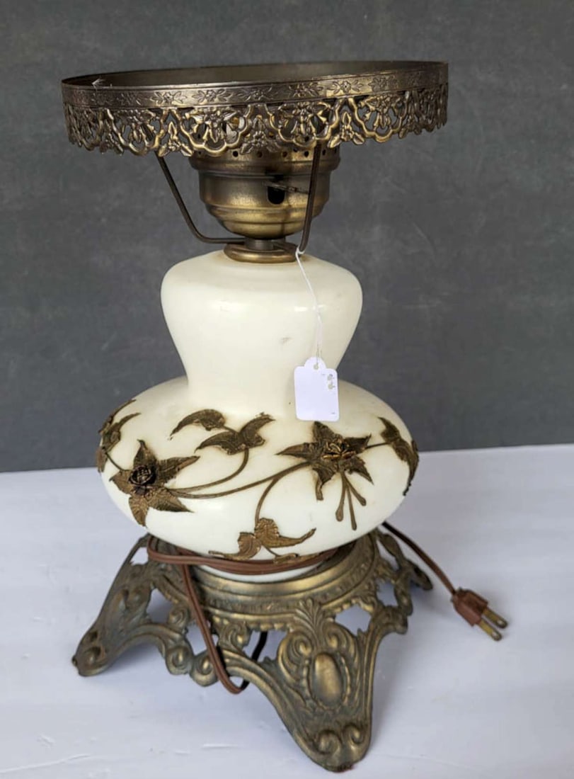 vintage glass and brass overlay table lamp: not sure if this was originally a vase or a converted oil lamp (?), brass footed base and shade rim (no shade) with a white glass body with brass or gilt bronze floral overlay