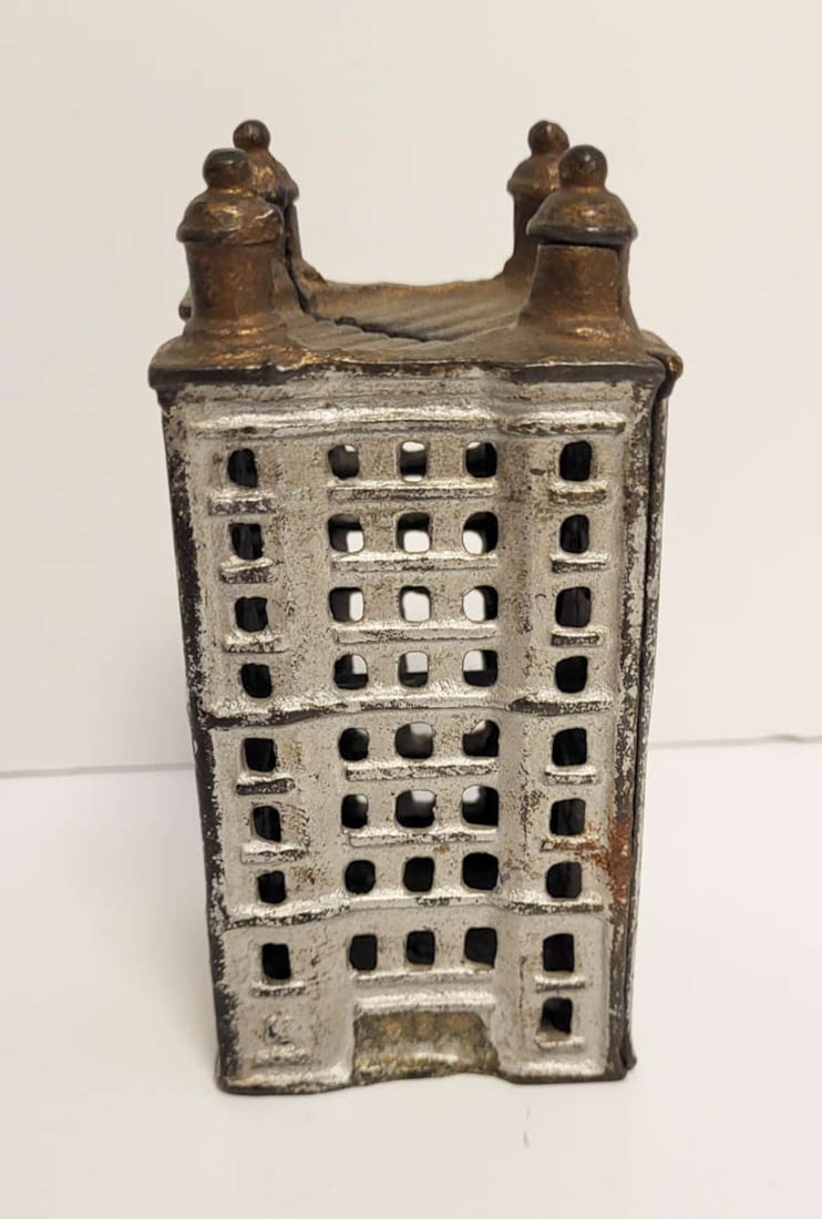antique painted cast iron coin bank: antique bank building shaped penny or coin bank, with painted silver and bronze accents, unmarked but most likely made by A.C. (Adam Clark) Williams see the next lot for a larger model