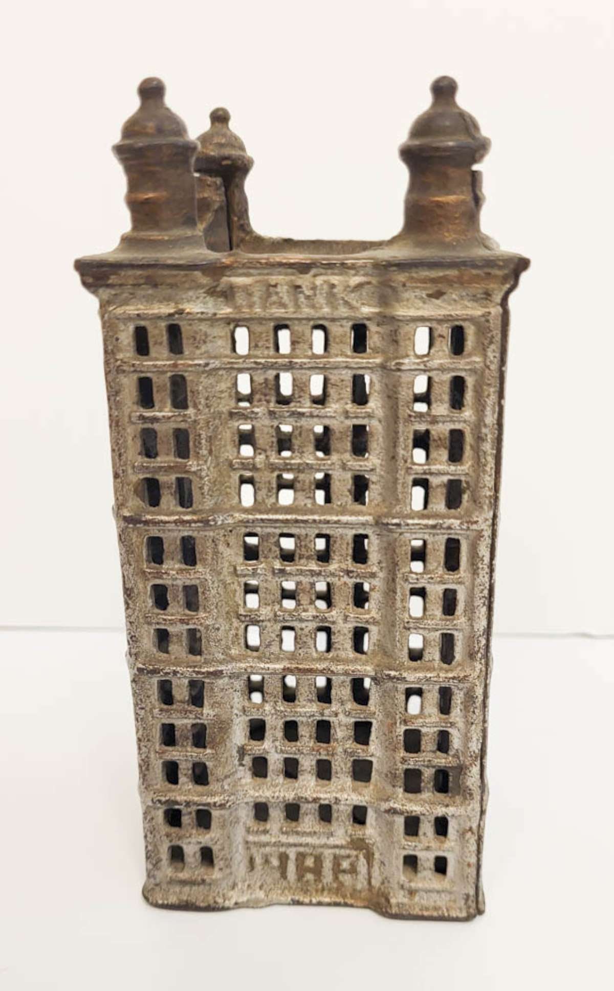 antique painted cast iron coin bank: antique bank building shaped penny or coin bank, with painted silver and bronze accents, unmarked but most likely made by A.C. (Adam Clark) Williams see the previous lot for the smaller mo